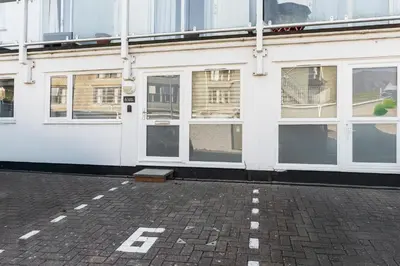 a white building with lots of windows on it at 6 Lower Talland Apartments in St Ives