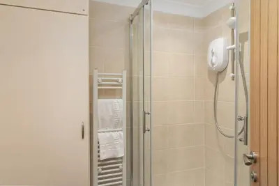 a bathroom with a shower with a glass door at 6 Lower Talland Apartments in St Ives