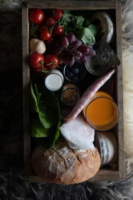 a wooden box filled with different types of food at Kudhva 2 in Treknow