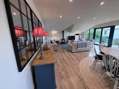 a living room with a table and a couch at Chupra in Saint Mawes