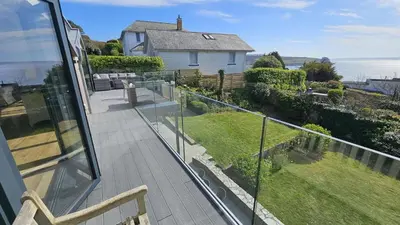 a balcony with a view of a house at Chupra in Saint Mawes