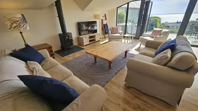 a living room with two couches and a coffee table at Chupra in Saint Mawes