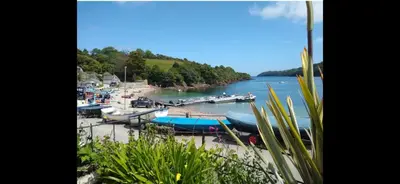 a group of boats docked at a dock on a river at Seaview Barns in Budock Water