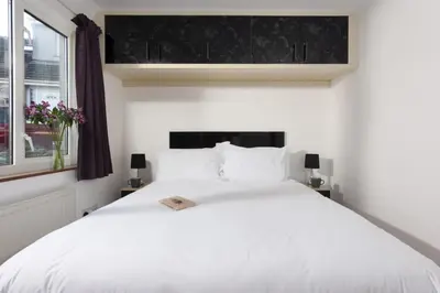 a bedroom with a white bed and a window at Ocean Parc in Carbis Bay