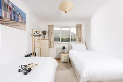 a bedroom with two beds and a window at Ocean Parc in Carbis Bay