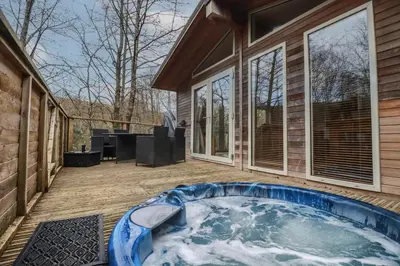 a hot tub on the deck of a house at 1 Miller's Island in Looe