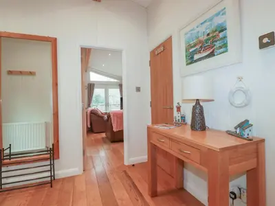 a room with a wooden desk and a living room at 1 Miller's Island in Looe