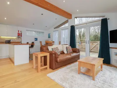 a living room with a couch and a table at 2 Miller's Island in Looe