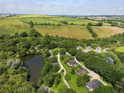an aerial view of a farm with a lake at 2 Miller's Island in Looe