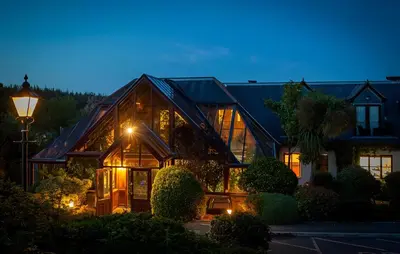 a large house with lights in front of it at Hustyns Hotel in Wadebridge
