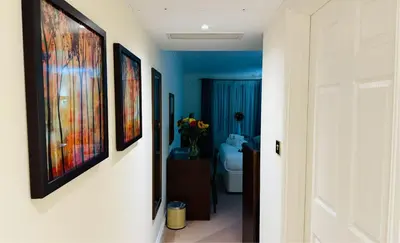 a hallway with paintings on the walls of a bathroom at Hustyns Hotel in Wadebridge