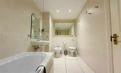 a bathroom with a tub and a sink and a toilet at Hustyns Hotel in Wadebridge