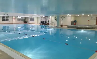 a large swimming pool with blue water at Hustyns Hotel in Wadebridge