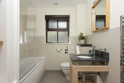 a bathroom with a sink and a tub and a toilet at Hustyns Hotel in Wadebridge