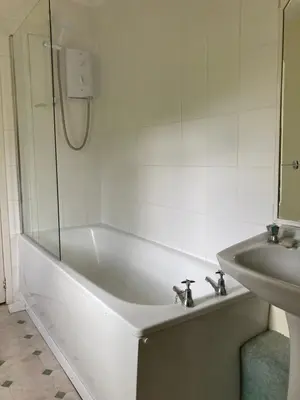 a bathroom with a bath tub and a sink at Roskear Farm in Wadebridge