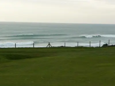 a golf course with the ocean in the background at 5 Hatfield Cresent in Newquay