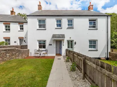 a white house with a wooden fence at Holiday Home Sea Compass by Interhome in Charlestown