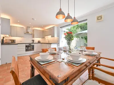 a kitchen and dining room with a wooden table at Holiday Home Sea Compass by Interhome in Charlestown