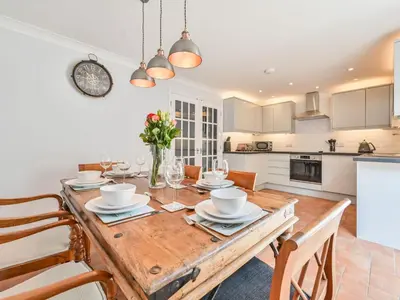 a kitchen and dining room with a wooden table and chairs at Holiday Home Sea Compass by Interhome in Charlestown