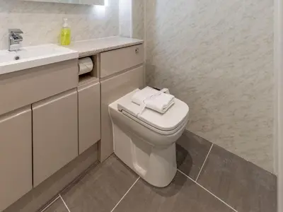 a white bathroom with a toilet and a sink at Holiday Home Sea Compass by Interhome in Charlestown
