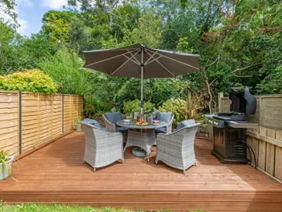 a patio with a table and chairs and an umbrella at Holiday Home Sea Compass by Interhome in Charlestown