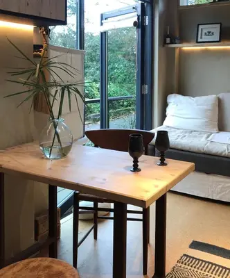 a living room with a table and a bed at Studio Portland in Falmouth