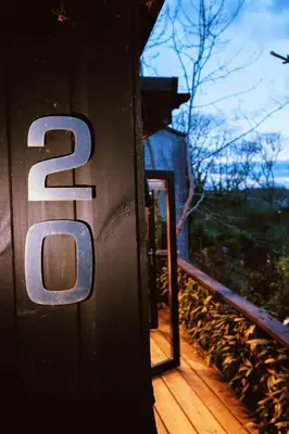 a sign on the side of a wooden deck at Studio Portland in Falmouth