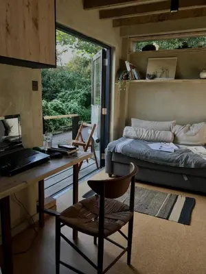 a living room with a desk and a bed and a desk at Studio Portland in Falmouth