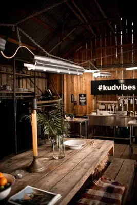 a kitchen with a wooden table in a restaurant at Kudhva 4 in Treknow