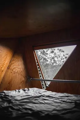 a small room with a window with a ladder at Kudhva 4 in Treknow
