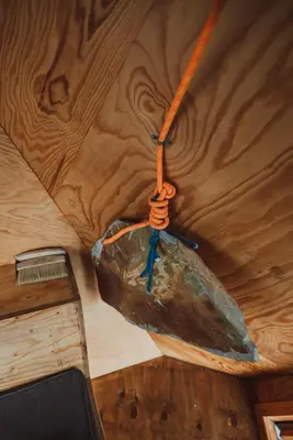 a rock on a orange rope hanging from a ceiling at Kudhva 4 in Treknow