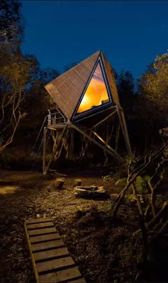 a tree house with a light in the middle at Kudhva 3 in Treknow