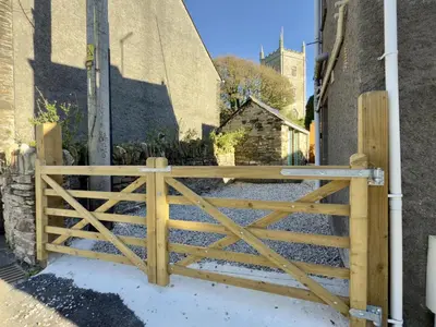 a wooden gate in front of a building at Rock Cottage in St. Issey