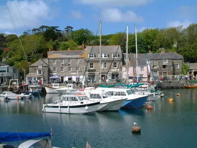 a group of boats are docked in a harbor at Rock Cottage in St. Issey