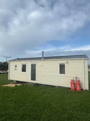 a mobile home in a field with two fire hydrants at Sea Shanty in Newquay