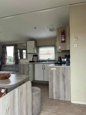a kitchen in an rv with a table and counters at Sea Shanty in Newquay