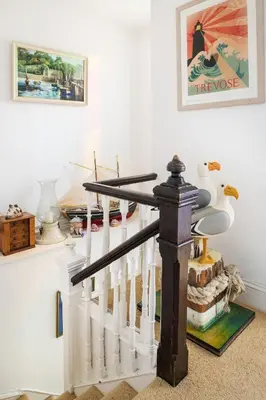 a staircase with white railings in a home at Beautiful family house with amazing sea views in Padstow