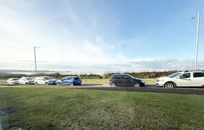 a group of cars parked in a parking lot at 8 Coastline Apartment in Newquay
