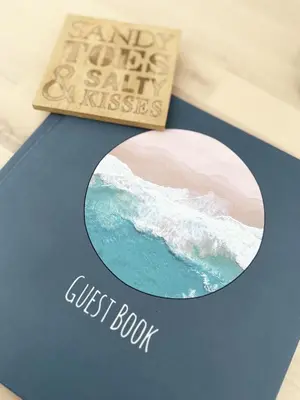 a book and ajust book sitting on a table at 8 Coastline Apartment in Newquay