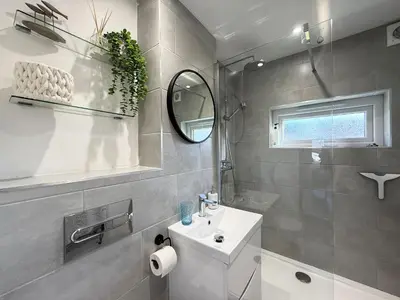 a bathroom with a white sink and a mirror at 8 Coastline Apartment in Newquay