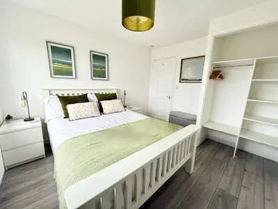 a bedroom with a large white bed in a room at 8 Coastline Apartment in Newquay