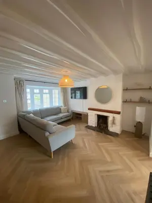 a living room with a couch and a fireplace at Mermaid Cove in Portreath