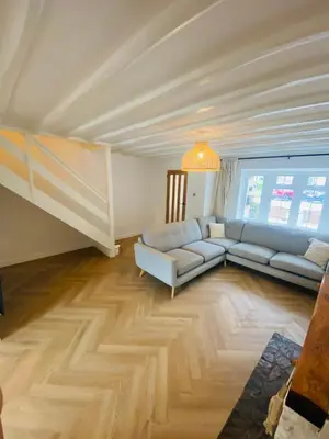 a living room with a couch and a large window at Mermaid Cove in Portreath