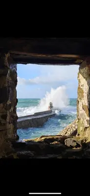 a view of the ocean through a window at Mermaid Cove in Portreath