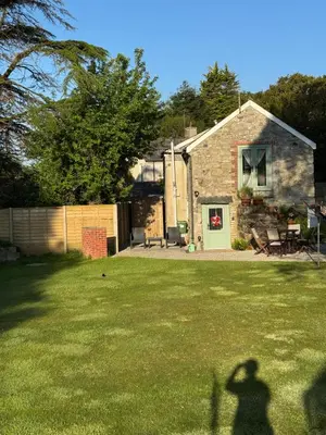a shadow of a person standing in front of a house at Blaise Cottage Cornwall in St Austell