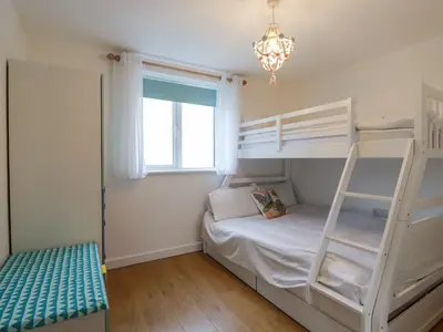 a bedroom with two bunk beds and a window at Apartment 6 in Newquay
