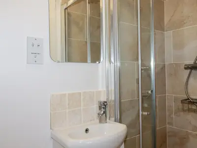 a bathroom with a sink and a shower at Apartment 6 in Newquay