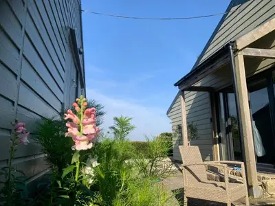 a house with a flower on the side of it at Field View in Liskeard