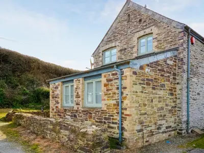 a brick house with windows on the side of it at Skiber An Hyli in Mawgan Porth