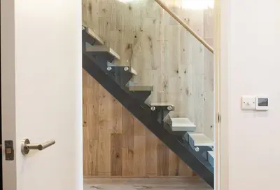a staircase in a room with a wooden wall at Lefransa in Carbis Bay, St Ives in Carbis Bay